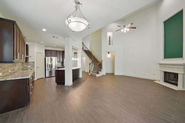 23 Castello Ln, Missouri City, TX 77459 - interior space featuring stainless steel refrigerator with ice dispenser, open floor plan, and a ceiling fan