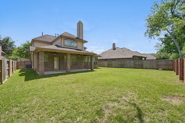 23 Castello Ln, Missouri City, TX 77459 - back of property featuring a patio, central AC unit, a fenced backyard, and a yard