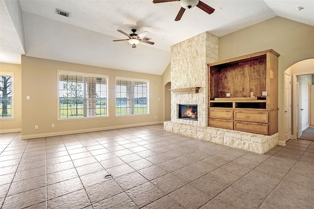 unfurnished living room with tile patterned flooring, visible vents, a fireplace, a ceiling fan, and vaulted ceiling