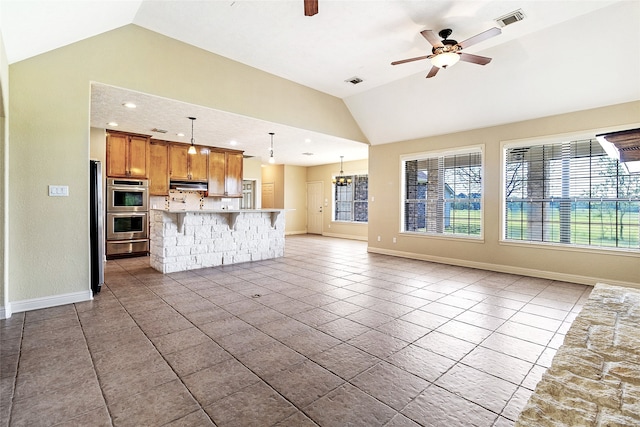 unfurnished living room featuring baseboards, vaulted ceiling, visible vents, and ceiling fan with notable chandelier