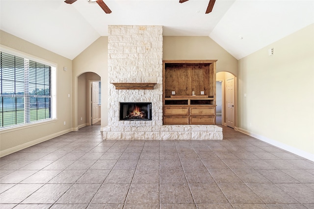 unfurnished living room with tile patterned flooring, a ceiling fan, and high vaulted ceiling