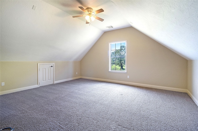 additional living space featuring ceiling fan, visible vents, carpet floors, baseboards, and lofted ceiling