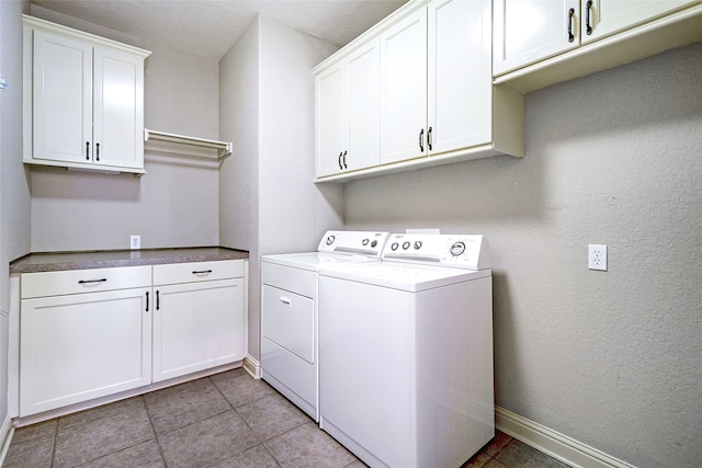 laundry room with independent washer and dryer, light tile patterned flooring, baseboards, and cabinet space