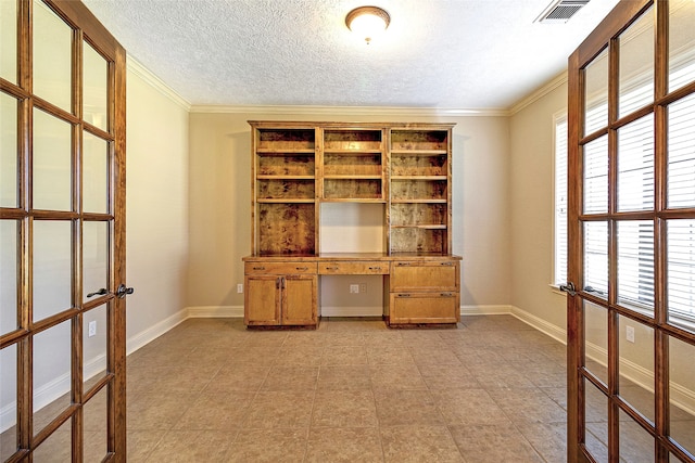 unfurnished office featuring crown molding, visible vents, baseboards, a textured ceiling, and french doors