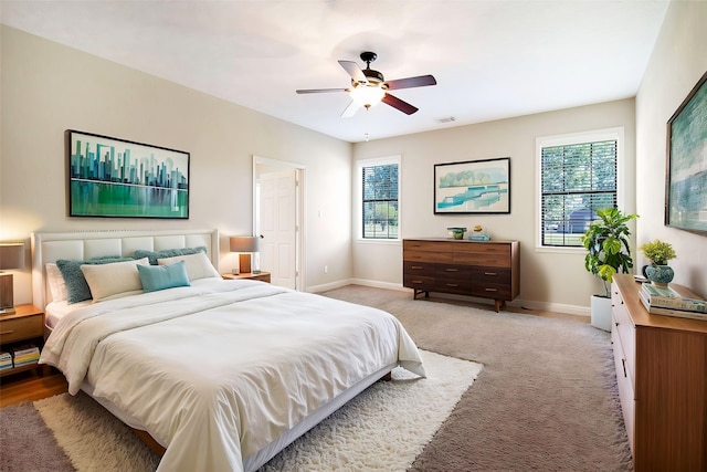 bedroom with baseboards, visible vents, and multiple windows