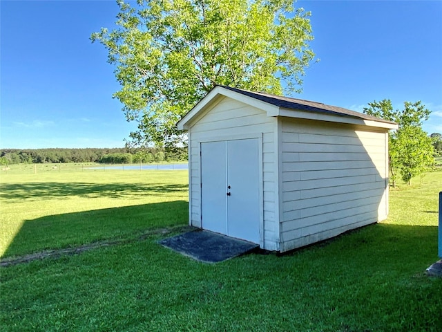 view of shed with a water view