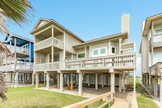 2330 Blue Water Hwy, Surfside Beach, TX 77541 - rear view of property with a lawn, a chimney, and a carport