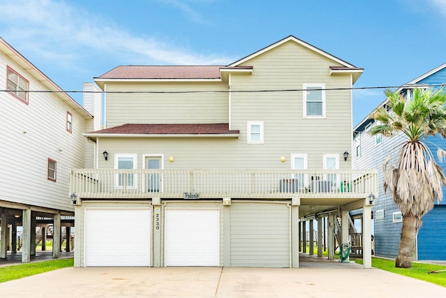 2330 Blue Water Hwy, Surfside Beach, TX 77541 - rear view of property featuring driveway, roof with shingles, and a garage