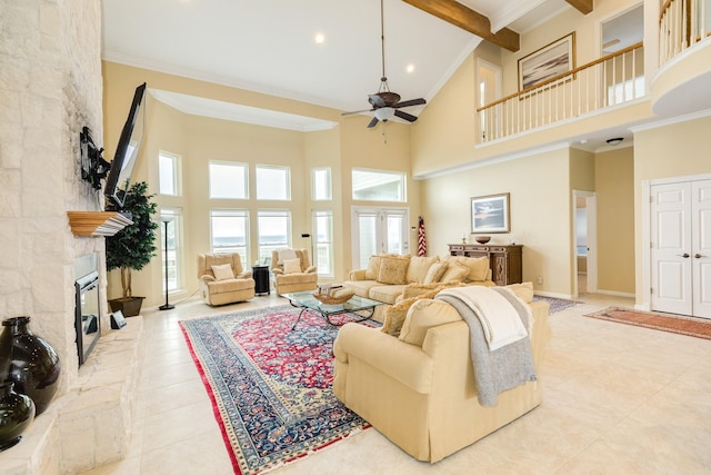 2330 Blue Water Hwy, Surfside Beach, TX 77541 - living room featuring ceiling fan, beam ceiling, tile patterned floors, high vaulted ceiling, and a stone fireplace