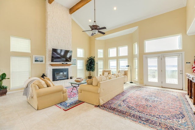 2330 Blue Water Hwy, Surfside Beach, TX 77541 - living area featuring crown molding, a healthy amount of sunlight, high vaulted ceiling, and a large fireplace