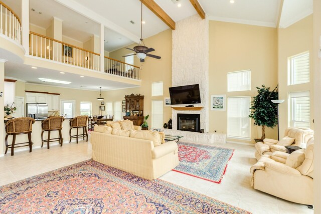 2330 Blue Water Hwy, Surfside Beach, TX 77541 - living area with light tile patterned floors, high vaulted ceiling, ceiling fan, and beam ceiling