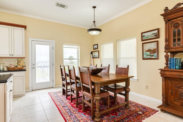 2330 Blue Water Hwy, Surfside Beach, TX 77541 - dining room featuring crown molding, baseboards, visible vents, and light tile patterned floors