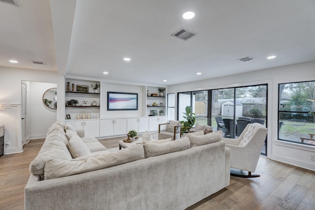 10503 Metronome Dr, Houston, TX 77043 - living area featuring light wood-style floors, recessed lighting, and visible vents