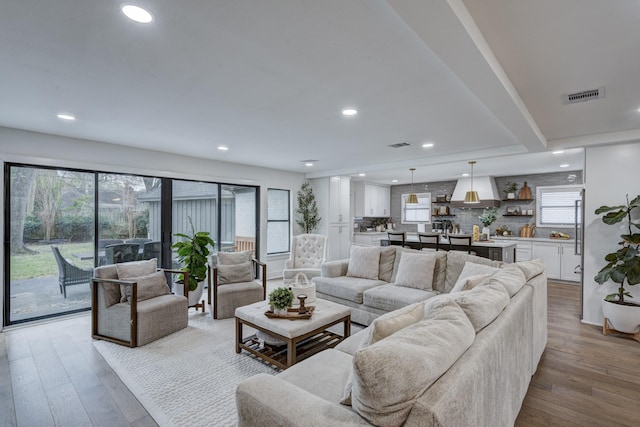 10503 Metronome Dr, Houston, TX 77043 - living room with recessed lighting, visible vents, a wealth of natural light, and wood finished floors
