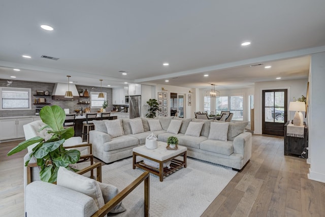 10503 Metronome Dr, Houston, TX 77043 - living room featuring visible vents, light wood-type flooring, recessed lighting, and a wealth of natural light