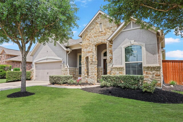 view of front of property featuring concrete driveway, stucco siding, a front yard, and stone siding