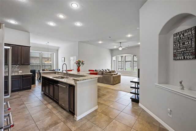 kitchen with a sink, ceiling fan, recessed lighting, and a wealth of natural light
