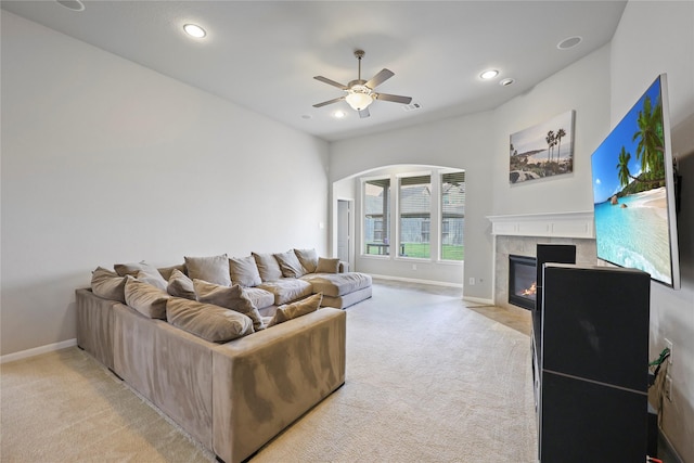 10418 Texas Sage Way, Cypress, TX 77433 - living room featuring light colored carpet, a tiled fireplace, ceiling fan, recessed lighting, and arched walkways
