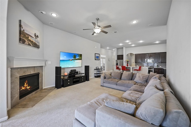 10418 Texas Sage Way, Cypress, TX 77433 - living room with light colored carpet, a ceiling fan, a fireplace, and recessed lighting