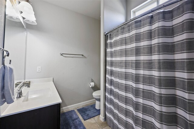 full bath with curtained shower, vanity, tile patterned floors, baseboards, and toilet