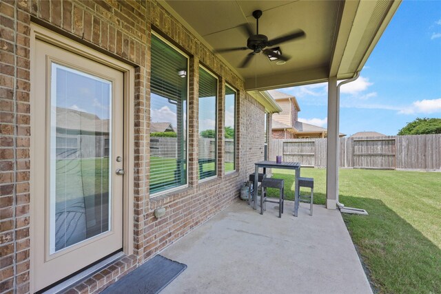 view of patio featuring fence and ceiling fan