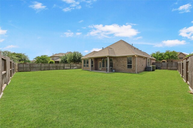 view of yard with a patio, central AC unit, and a fenced backyard