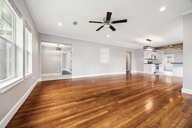 unfurnished living room featuring crown molding, recessed lighting, and wood finished floors