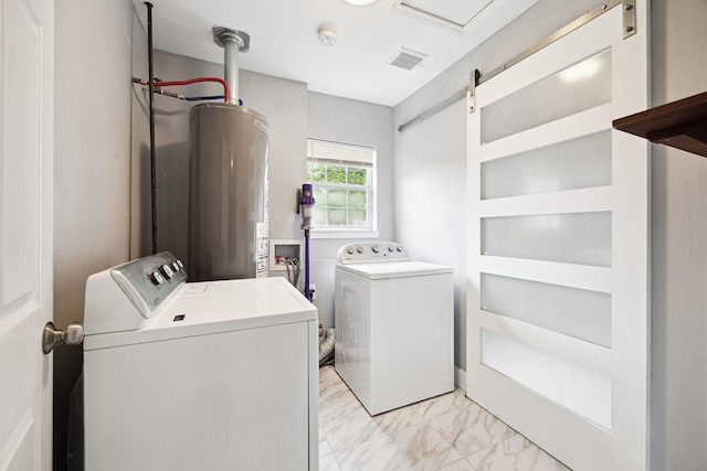 laundry area with washer and dryer, marble finish floor, laundry area, and water heater