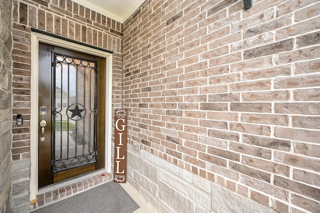 property entrance with brick siding