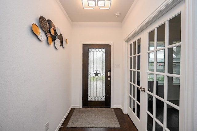 doorway to outside featuring baseboards, dark wood finished floors, and a healthy amount of sunlight