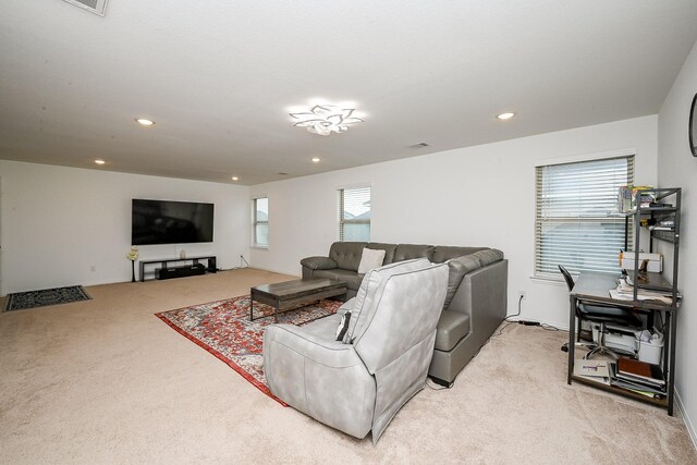living area with visible vents, recessed lighting, and light colored carpet