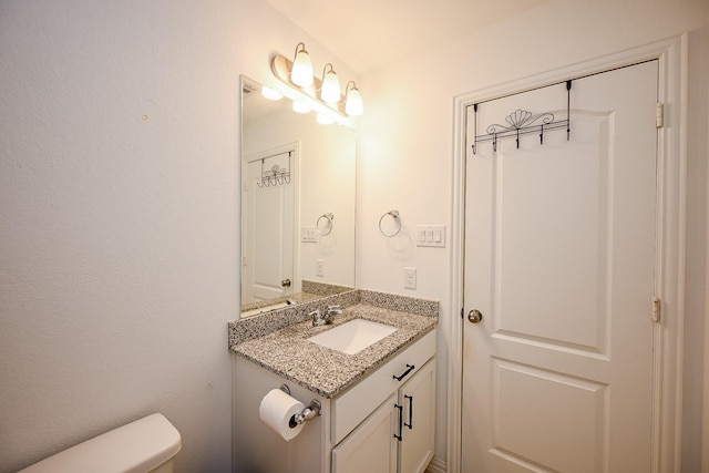 bathroom with toilet and vanity