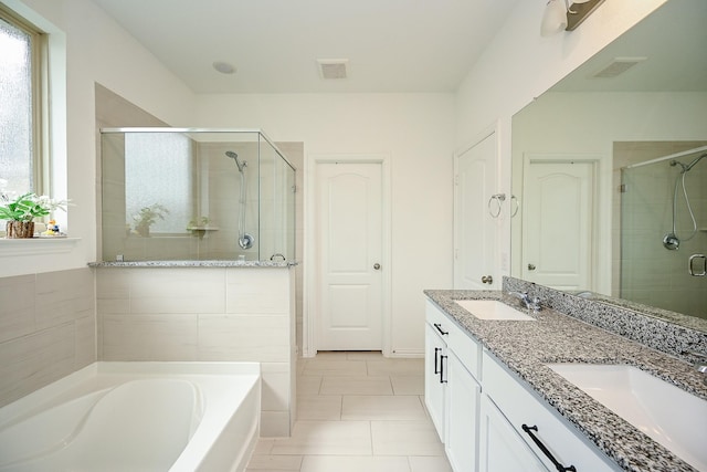 bathroom with a sink, a shower stall, a garden tub, and visible vents