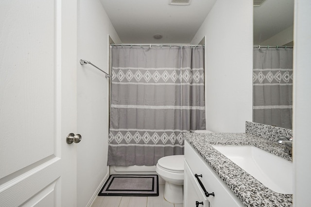 bathroom with toilet, a shower with curtain, visible vents, and vanity