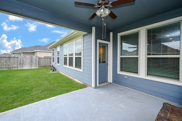 view of patio with fence and a ceiling fan