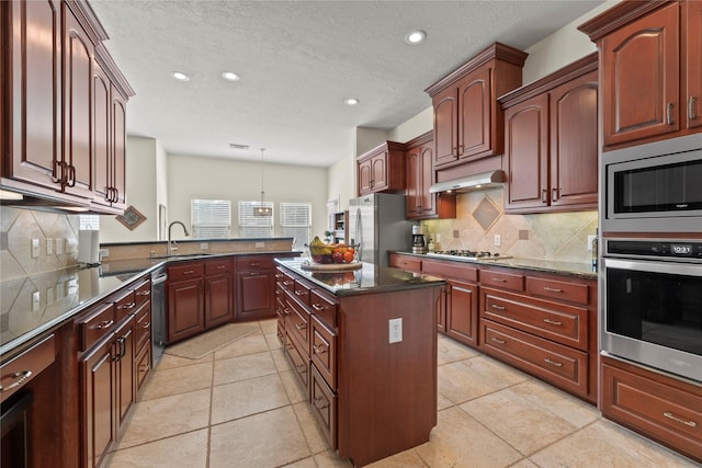 17714 W Copper Lakes Dr, Houston, TX 77095 - kitchen with appliances with stainless steel finishes, a sink, recessed lighting, backsplash, and under cabinet range hood