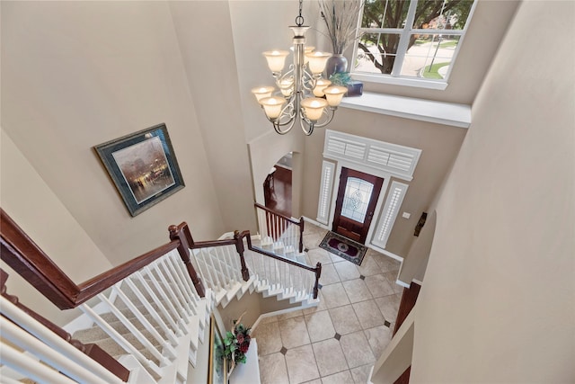 17714 W Copper Lakes Dr, Houston, TX 77095 - foyer featuring light tile patterned flooring, a high ceiling, a chandelier, and plenty of natural light