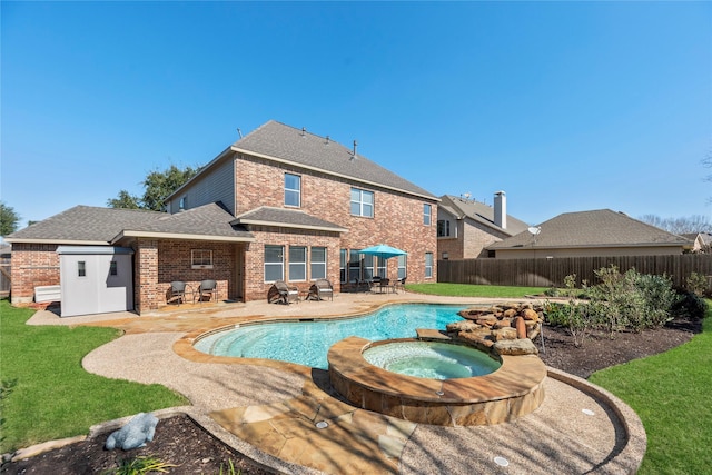 17714 W Copper Lakes Dr, Houston, TX 77095 - view of pool featuring a lawn, a pool with connected hot tub, a fenced backyard, and a patio area
