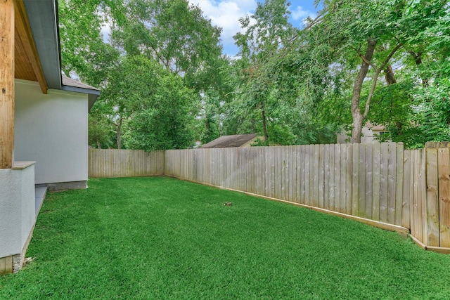view of yard with a fenced backyard