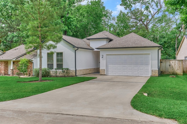 view of front of home with fence, concrete driveway, a shingled roof, stone siding, and stucco siding