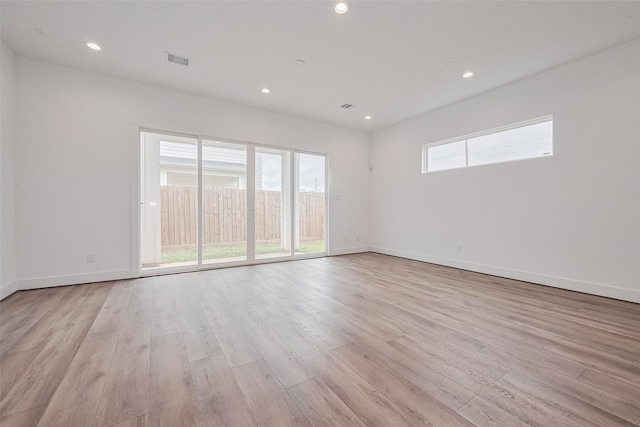 empty room with visible vents, recessed lighting, light wood-style flooring, and baseboards
