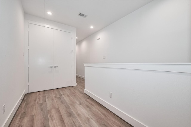 unfurnished bedroom featuring light wood-style flooring, recessed lighting, baseboards, visible vents, and a closet