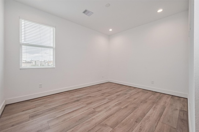 empty room featuring baseboards, recessed lighting, light wood-style flooring, and visible vents