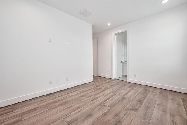 spare room with recessed lighting, baseboards, light wood finished floors, and visible vents