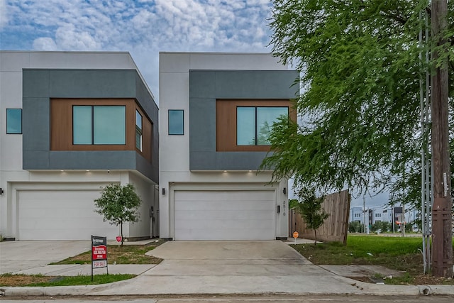 contemporary house featuring a garage, stucco siding, and concrete driveway