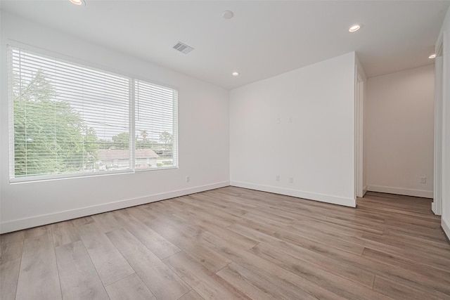spare room with recessed lighting, baseboards, visible vents, and light wood finished floors