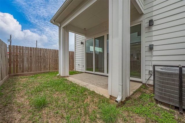 view of yard featuring a patio, fence, and cooling unit