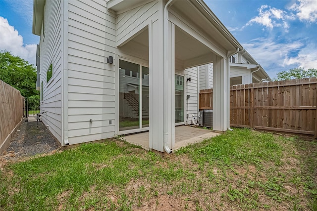 back of house featuring a fenced backyard and a patio