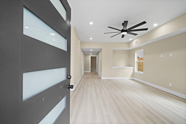 unfurnished room with ceiling fan, visible vents, baseboards, recessed lighting, and light wood-style flooring