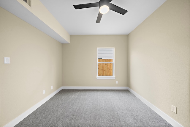 carpeted empty room with baseboards and ceiling fan